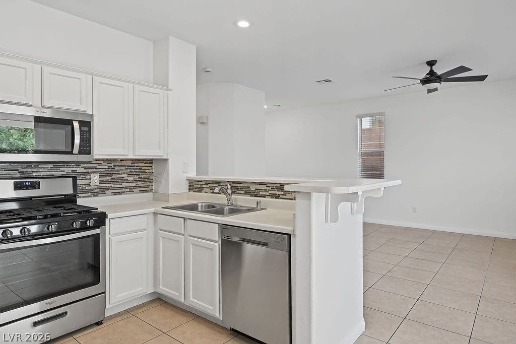 754 Solitude Point Avenue, Henderson, NV 89012 An open layout connects the kitchen to the tiled living area beyond.