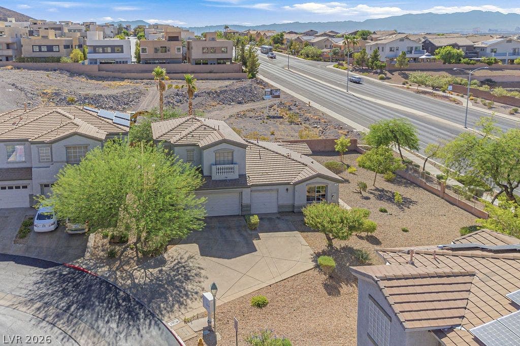 754 Solitude Point Avenue, Henderson, NV 89012 An aerial perspective captures the concrete driveway and tile roof of this desert-landscaped property.