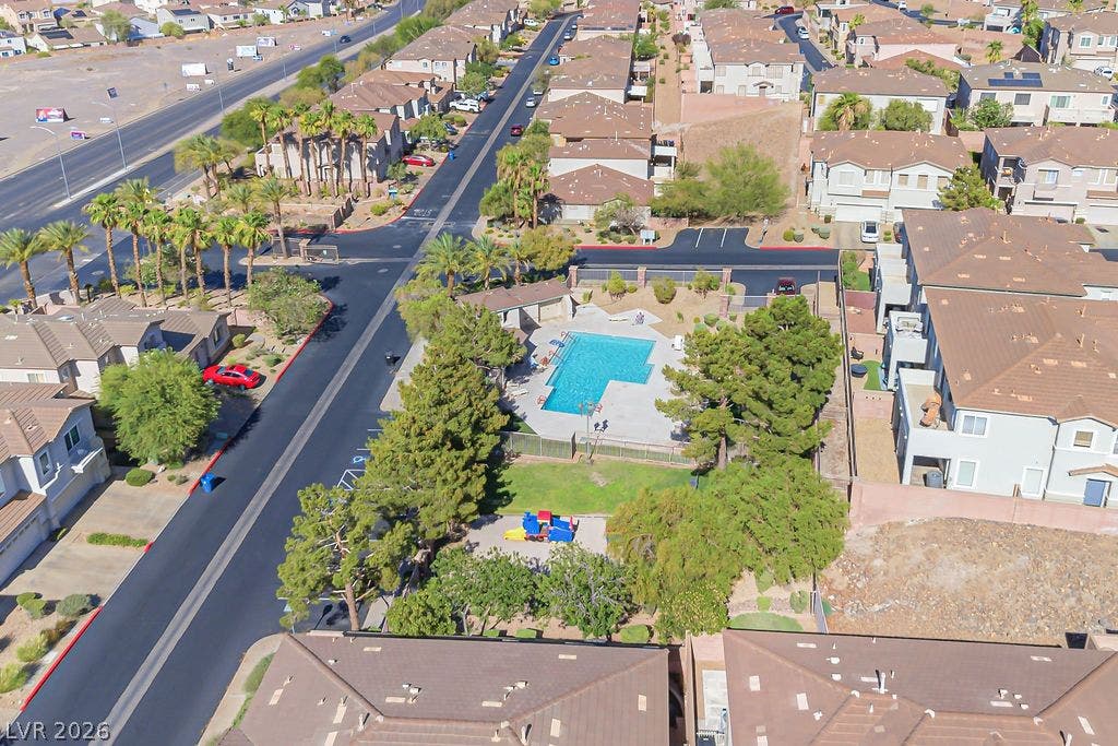 754 Solitude Point Avenue, Henderson, NV 89012 An aerial perspective shows a neighborhood community area featuring a swimming pool and playground structure.