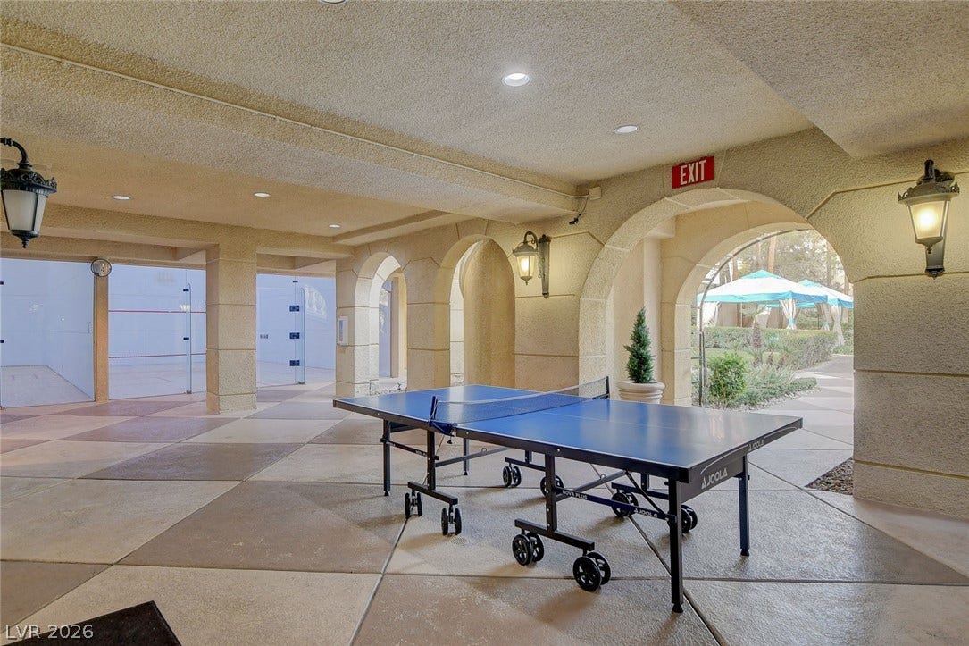 Arched passageways frame views of the landscaped courtyard from this covered outdoor recreation area.