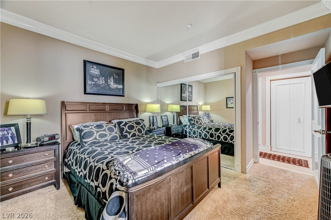 Plush carpeting and elegant crown molding elevate this serene personal retreat.