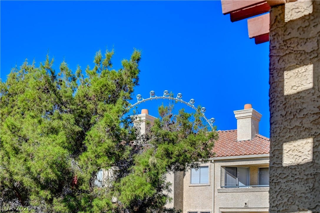 Lush mature trees partially frame views of the iconic LINQ  from the property.