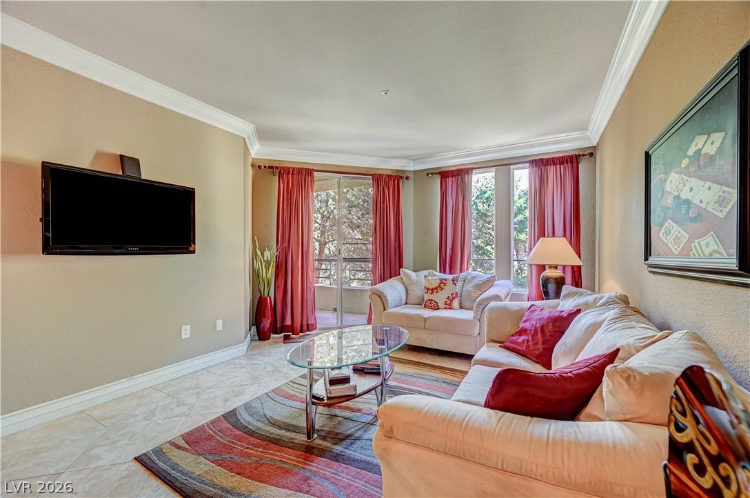 Elegant crown molding complements tile flooring in this inviting main living area.