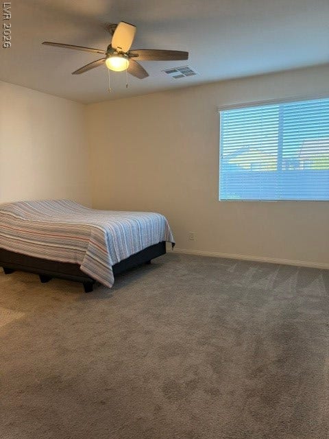 10764 Canary Blossom Avenue, Las Vegas, NV 89129 Soft carpeting pairs with a large window in this quiet secondary bedroom.