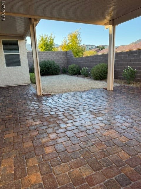 10764 Canary Blossom Avenue, Las Vegas, NV 89129 A spacious covered patio features extensive brick paver flooring alongside a low-maintenance yard.