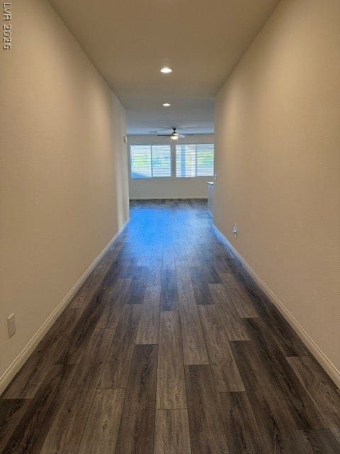 10764 Canary Blossom Avenue, Las Vegas, NV 89129 Gleaming wood-look floors stretch through this inviting, open hallway toward natural light.