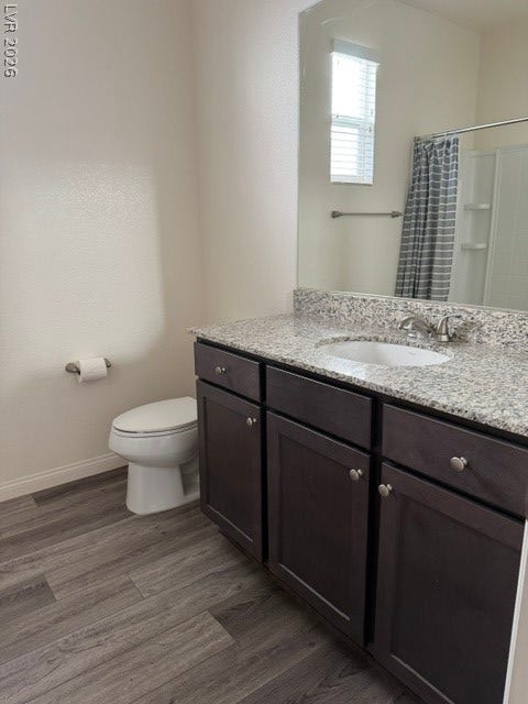10764 Canary Blossom Avenue, Las Vegas, NV 89129 A classic stone-topped vanity with dark cabinetry grounds this sleek restroom.
