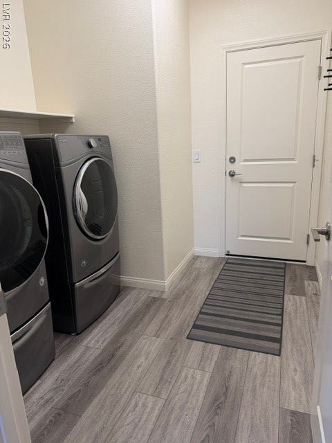 10764 Canary Blossom Avenue, Las Vegas, NV 89129 Modern durable flooring pairs beautifully with high-efficiency laundry appliances in this functional space.