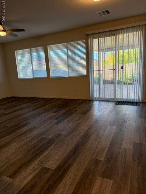 10764 Canary Blossom Avenue, Las Vegas, NV 89129 Rich wood plank flooring runs throughout this spacious living area with sliding glass doors.