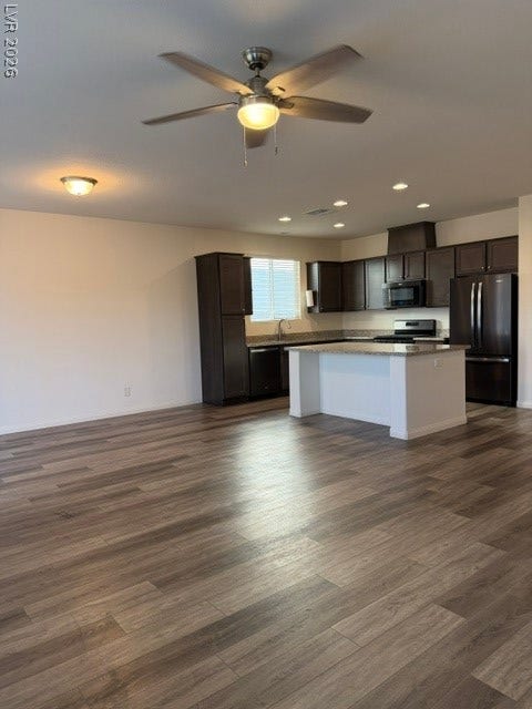 10764 Canary Blossom Avenue, Las Vegas, NV 89129 Warm wood-style flooring anchors this open layout connecting seamlessly to a contemporary kitchen.