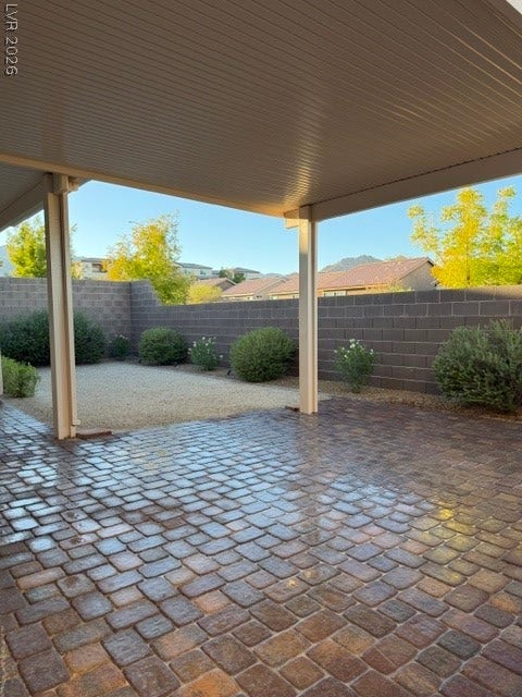 10764 Canary Blossom Avenue, Las Vegas, NV 89129 A covered patio opens to a beautifully paved backyard surrounded by a privacy wall.