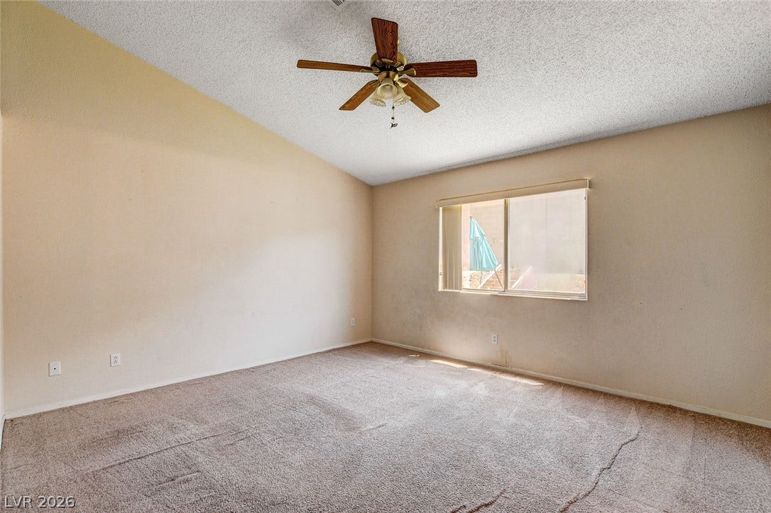 811 Rio Poco Court, Henderson, NV 89015 Vaulted ceilings and soft carpeting create a comfortable, inviting atmosphere in this bedroom.