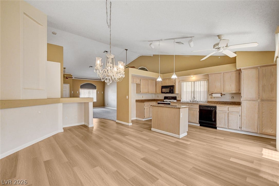 811 Rio Poco Court, Henderson, NV 89015 Plank flooring and vaulted ceilings frame this open-concept kitchen and adjoining dining area.
