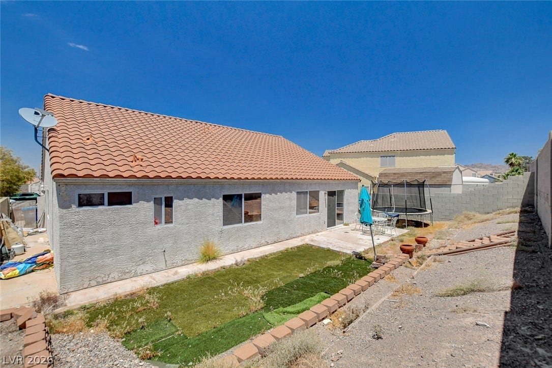 811 Rio Poco Court, Henderson, NV 89015 A terracotta tile roof accents this classic stucco home with sliding glass door access.
