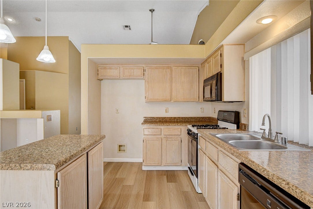 811 Rio Poco Court, Henderson, NV 89015 Gleaming stone countertops and classic wood cabinetry define this functional, light-filled culinary space.