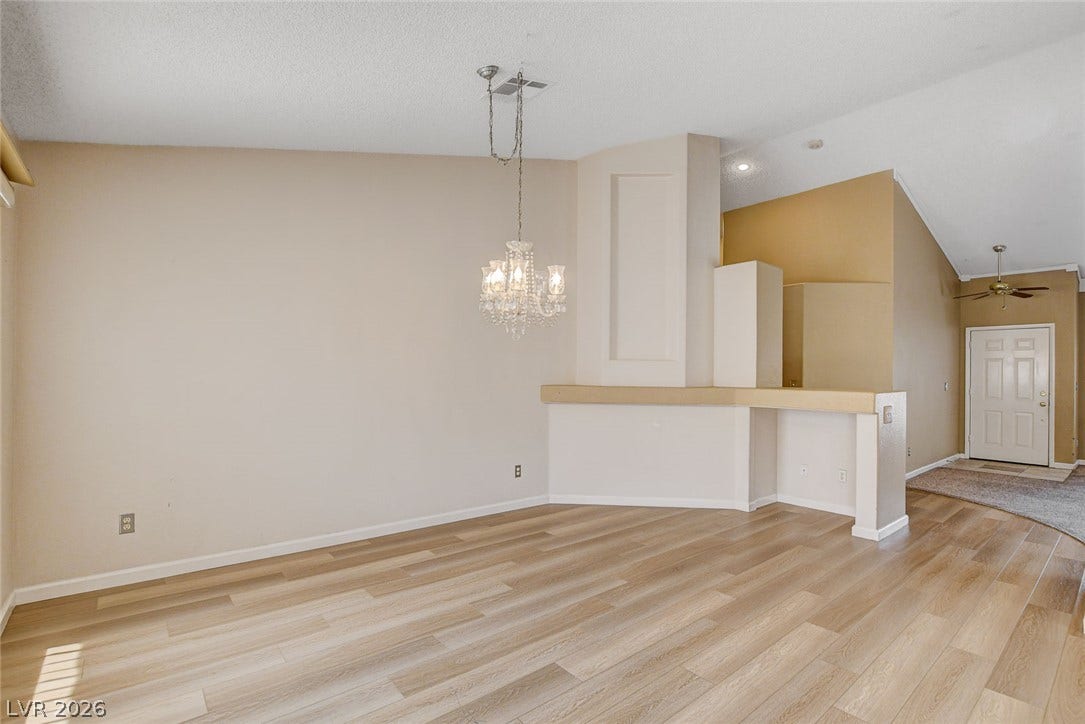 811 Rio Poco Court, Henderson, NV 89015 An elegant chandelier highlights the open-concept layout and clean architectural lines of this versatile space.