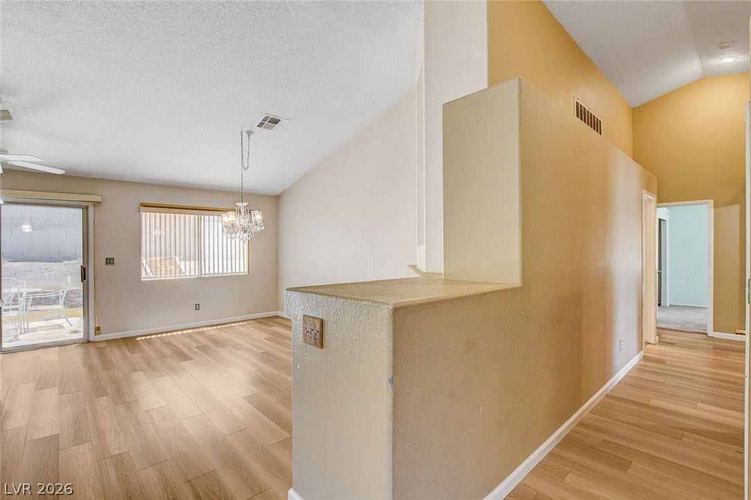 811 Rio Poco Court, Henderson, NV 89015 Vaulted ceilings and wood-look flooring enhance this inviting, open-concept living space.