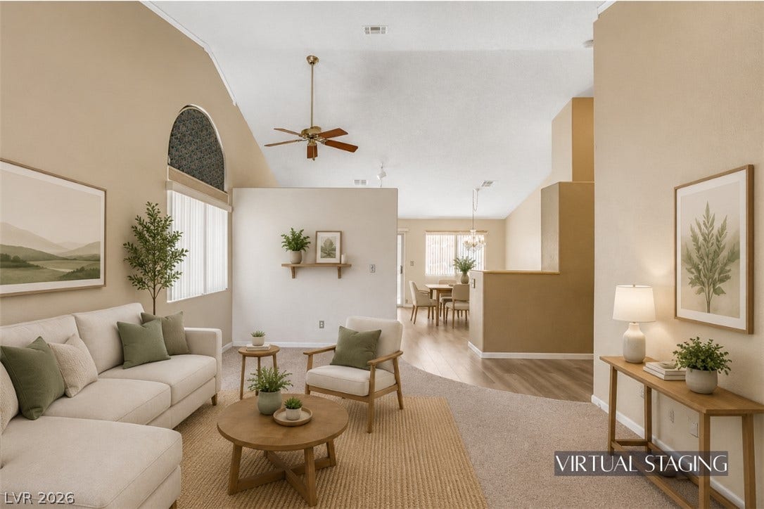 811 Rio Poco Court, Henderson, NV 89015 Vaulted ceilings soar over this airy living space transitioning into the dining area.