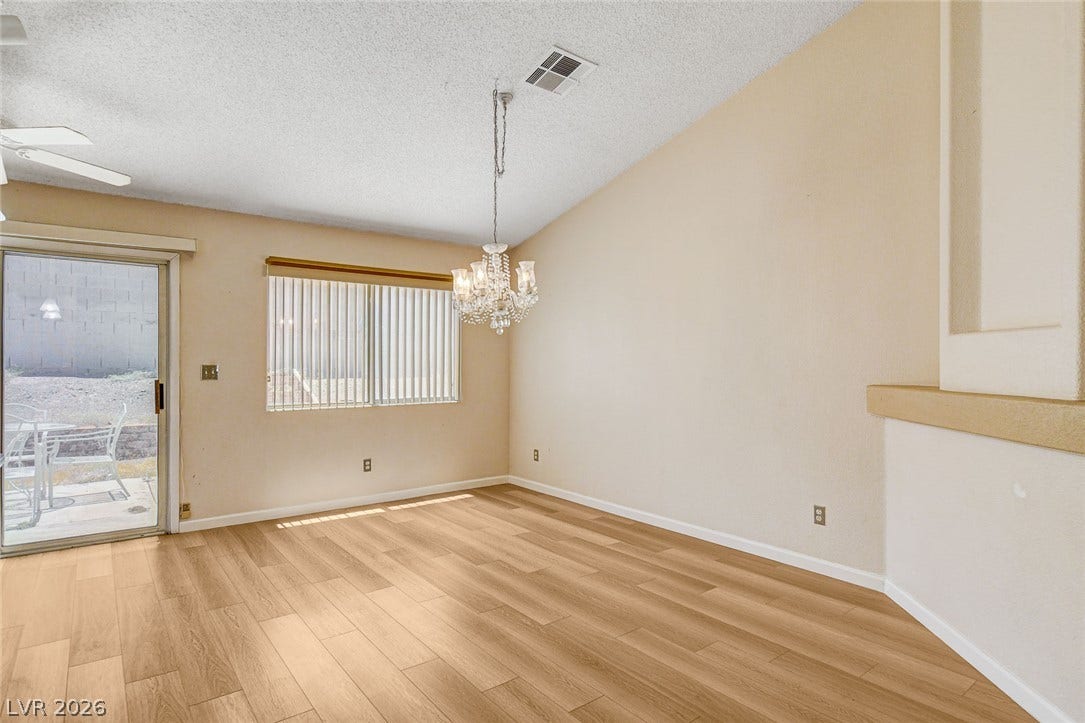 811 Rio Poco Court, Henderson, NV 89015 A vaulted ceiling and wood-look flooring enhance this inviting dining area with outdoor access.