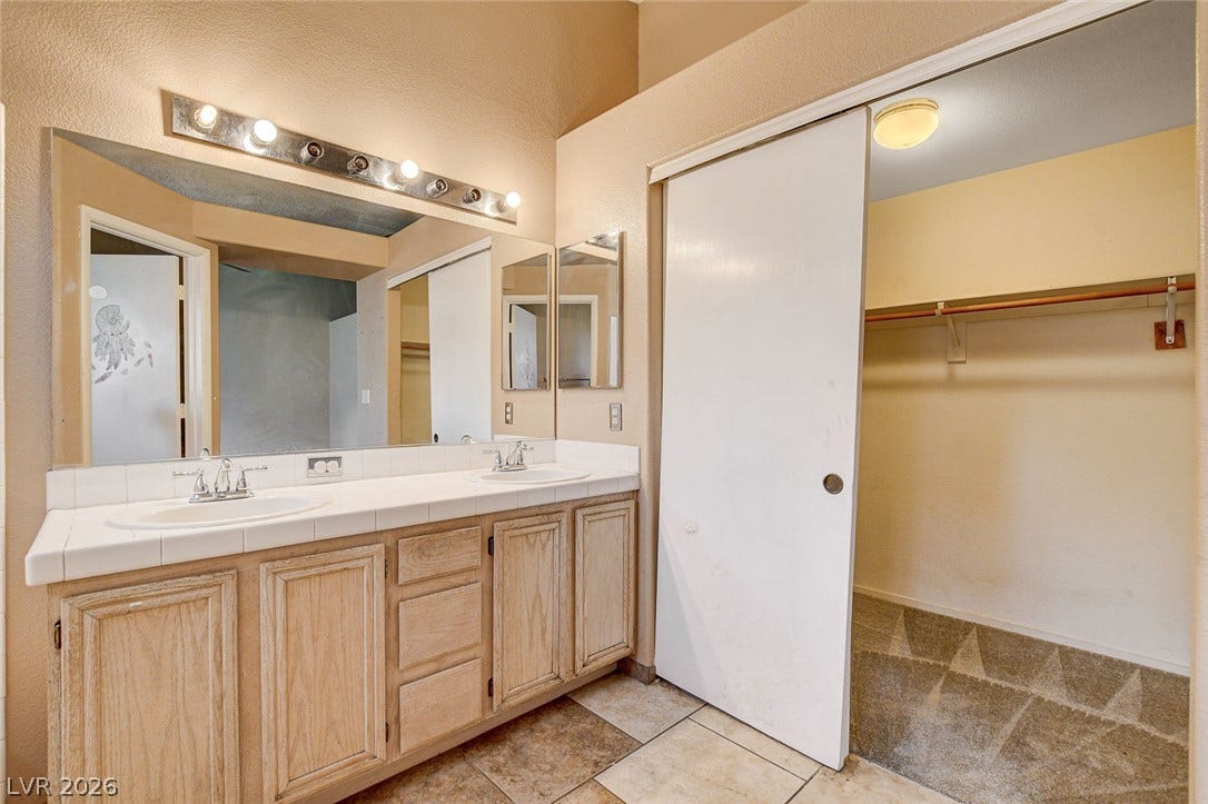 811 Rio Poco Court, Henderson, NV 89015 Tile flooring and a spacious vanity area connect to a large walk-in closet.