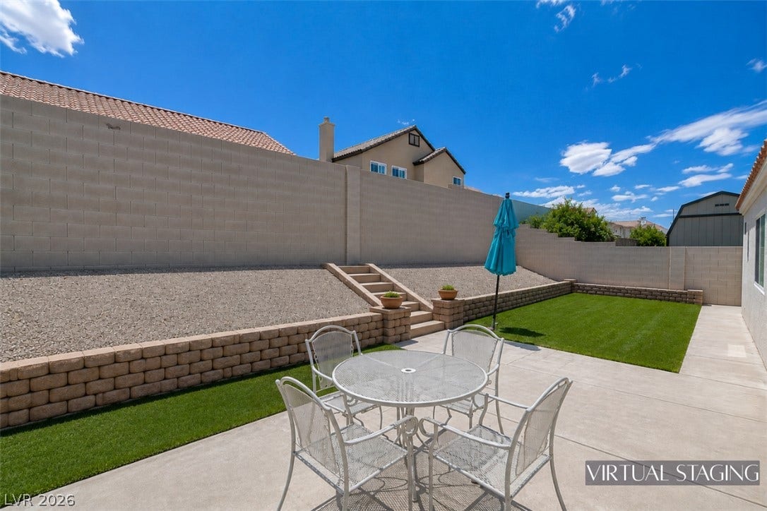 811 Rio Poco Court, Henderson, NV 89015 An enclosed backyard features terraced gravel beds and a concrete patio.