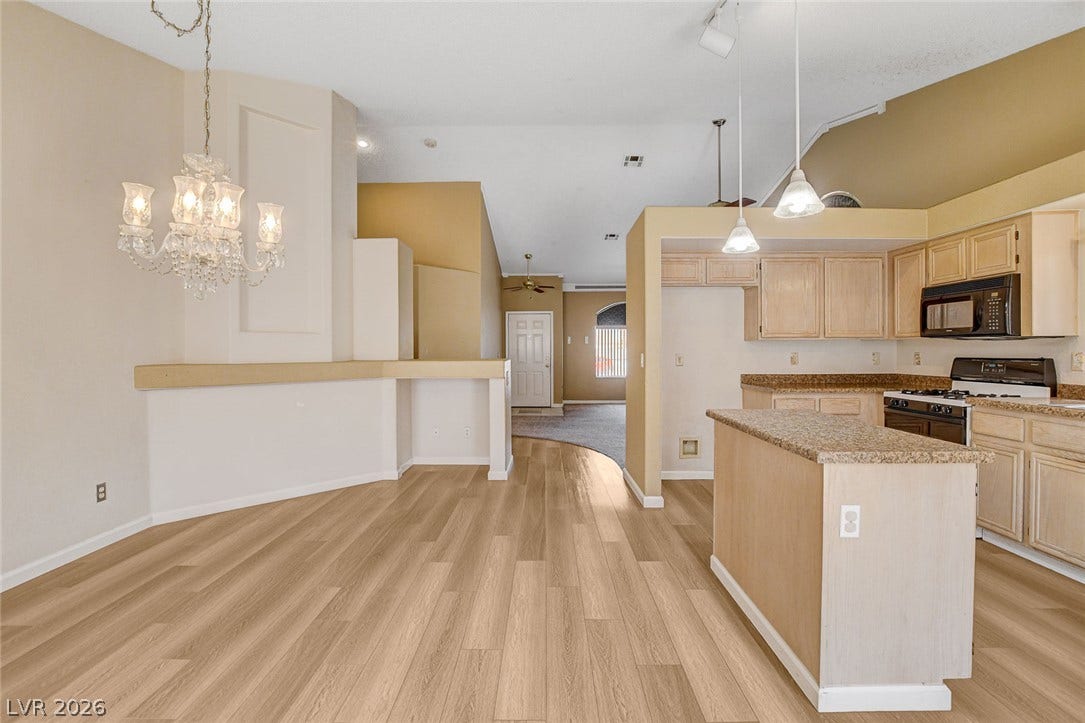 811 Rio Poco Court, Henderson, NV 89015 Warm wood flooring flows seamlessly through an open floorplan connecting the dining space and kitchen.