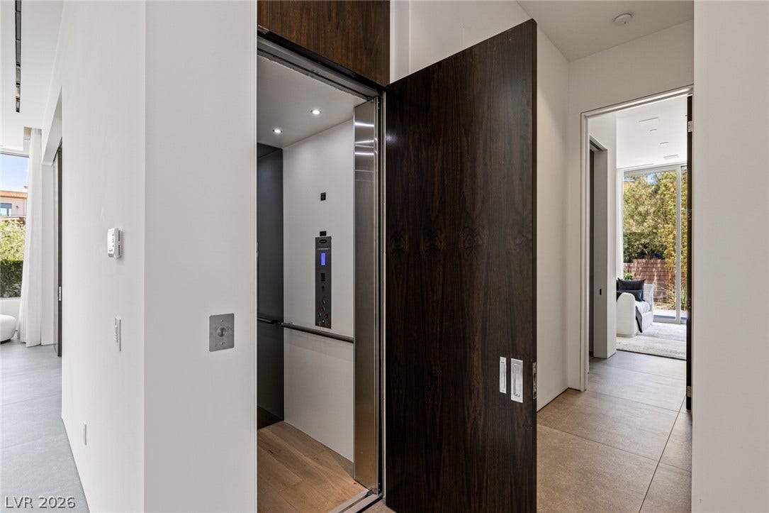 Streamlined elevator access provides seamless navigation between levels, complementing the adjacent living areas.
