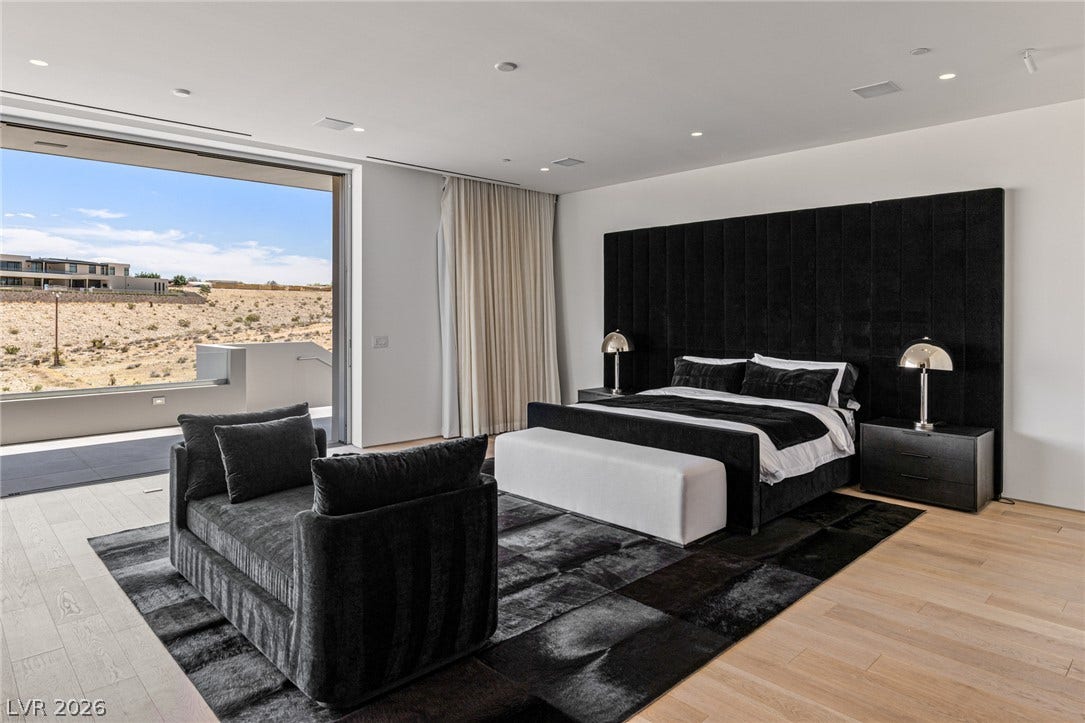 An inviting bedroom with abundant natural light and desert vistas.