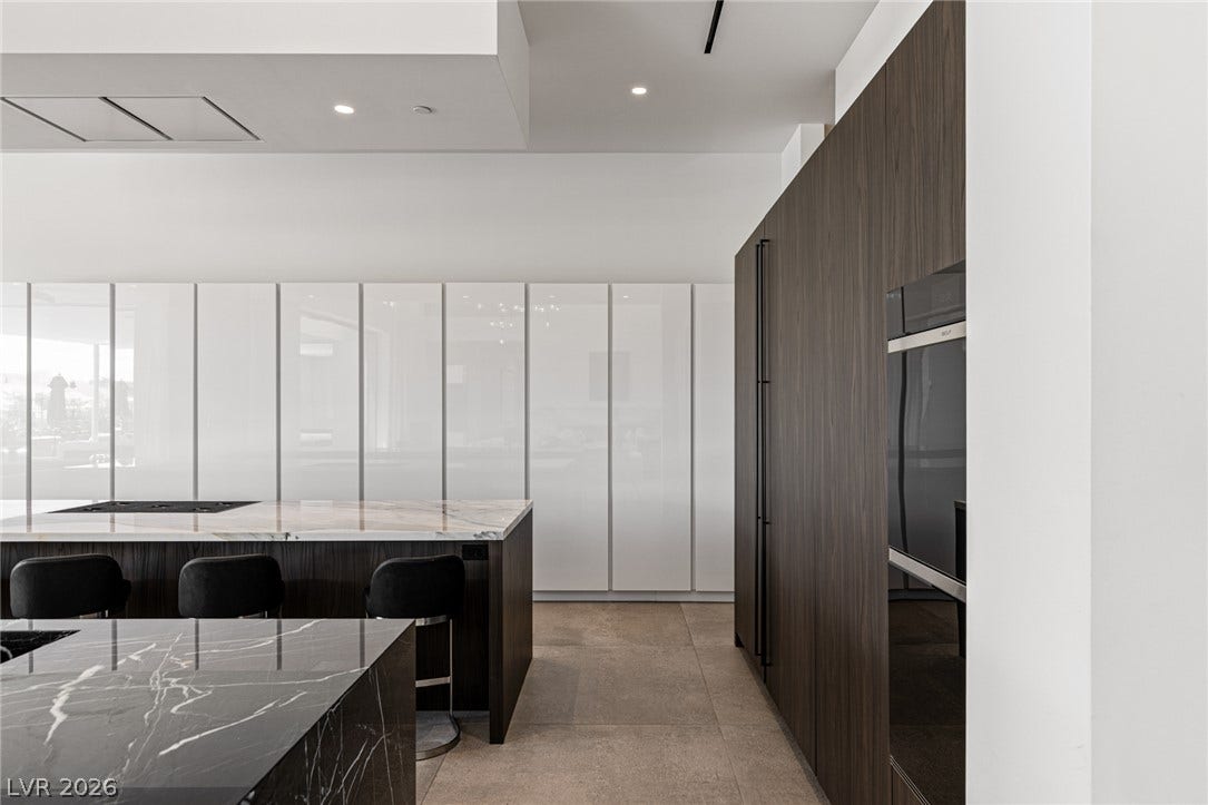 Culinary excellence awaits in this well-appointed kitchen featuring dual islands and integrated appliances.