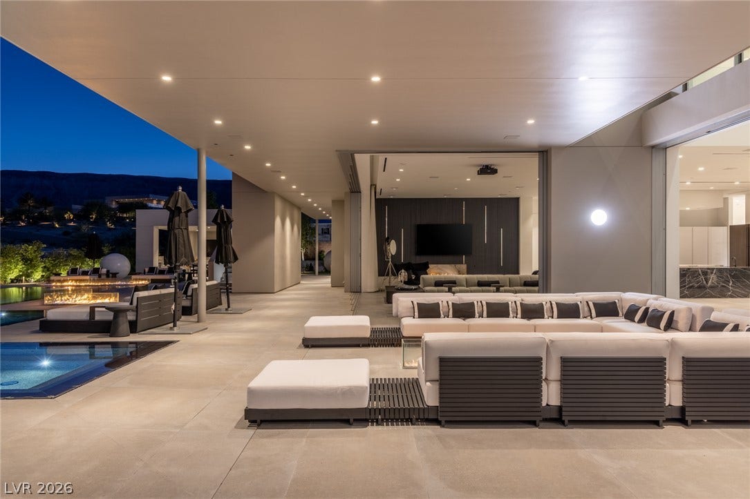 An inviting open-air lounge offers direct access to the interior and an elegant poolside fire pit.