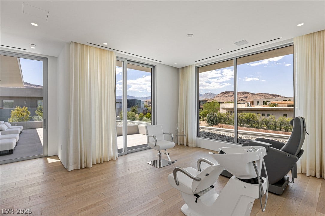 Floor-to-ceiling windows offer captivating mountain and city views from this versatile room.