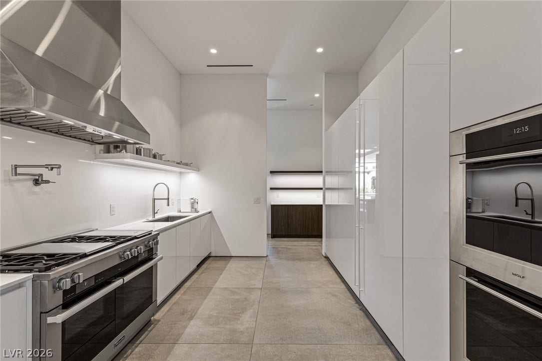 A sleek, contemporary kitchen with integrated appliances and streamlined cabinetry awaits the culinary enthusiast.