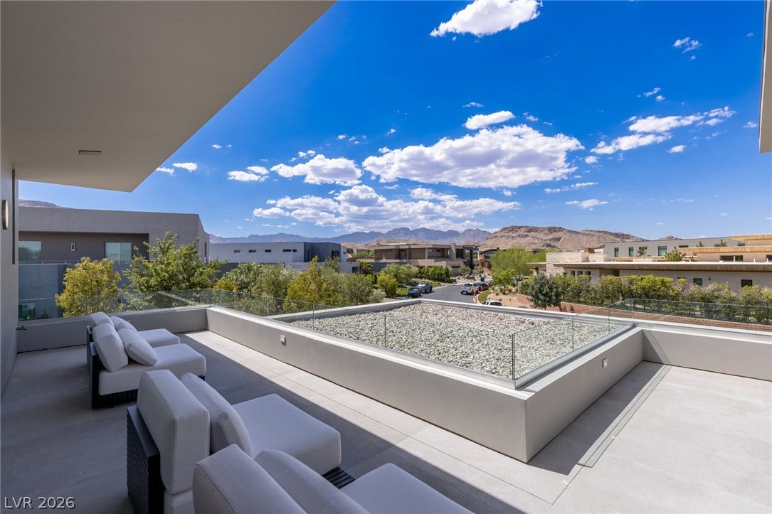 Unwind outdoors on this rooftop deck, offering sweeping views of the mountainous landscape and neighborhood.