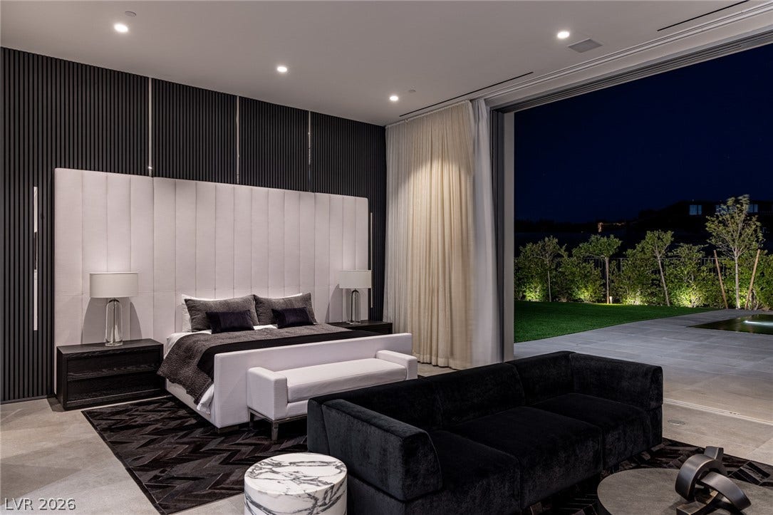 Retreat to a modern sanctuary with private outdoor access and subdued lighting.