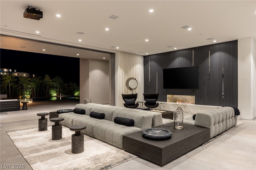 An inviting interior seamlessly flows to the exterior through a wide opening, perfect for entertaining.