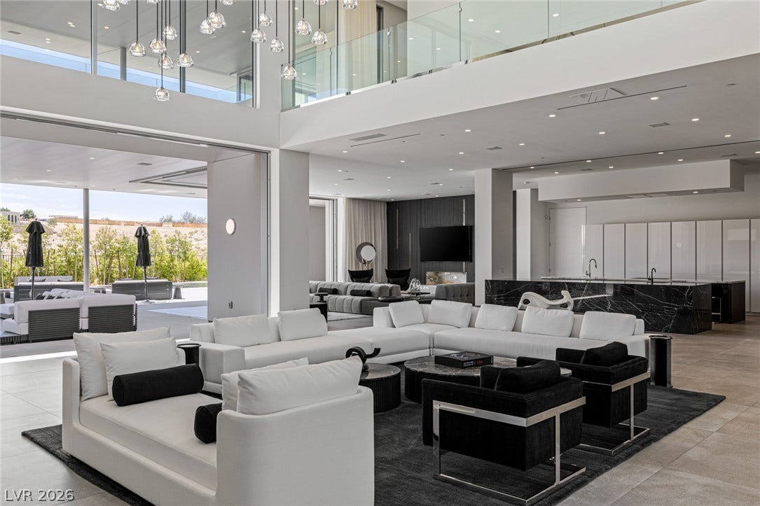 An open-concept living space with sleek flooring connects seamlessly to an outdoor lounge area.