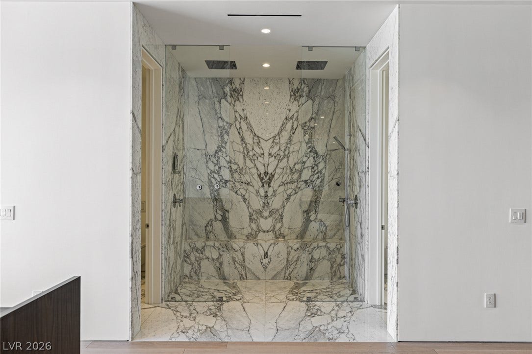 Luxurious marble shower enclosure offers an opulent bathing experience.