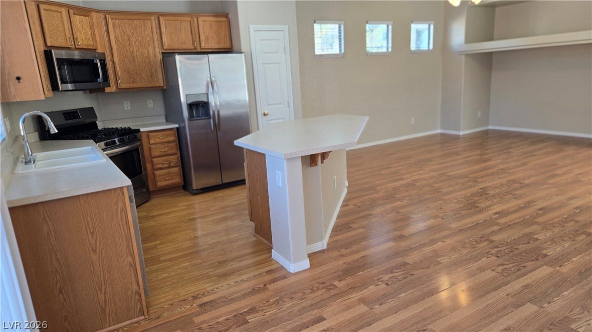 536 Civic Holiday Avenue, North Las Vegas, NV 89031 Gleaming hardwood floors flow from the kitchen into an airy, open-concept living space.