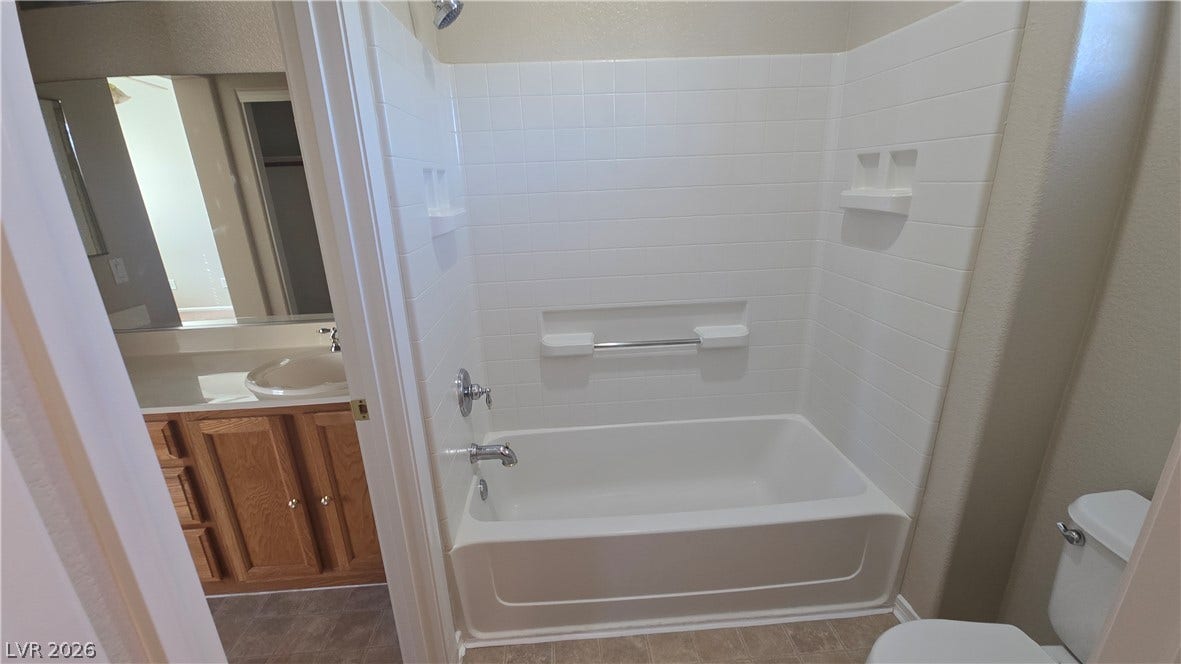 536 Civic Holiday Avenue, North Las Vegas, NV 89031 A classic bathtub is framed by crisp white tile surround and neutral flooring.