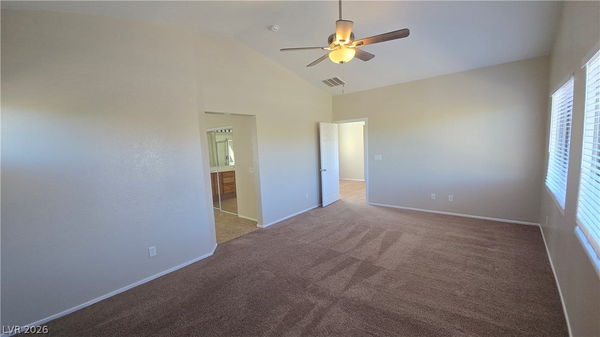 536 Civic Holiday Avenue, North Las Vegas, NV 89031 Vaulted ceilings and soft carpeting create a welcoming ambiance in this spacious bedroom.