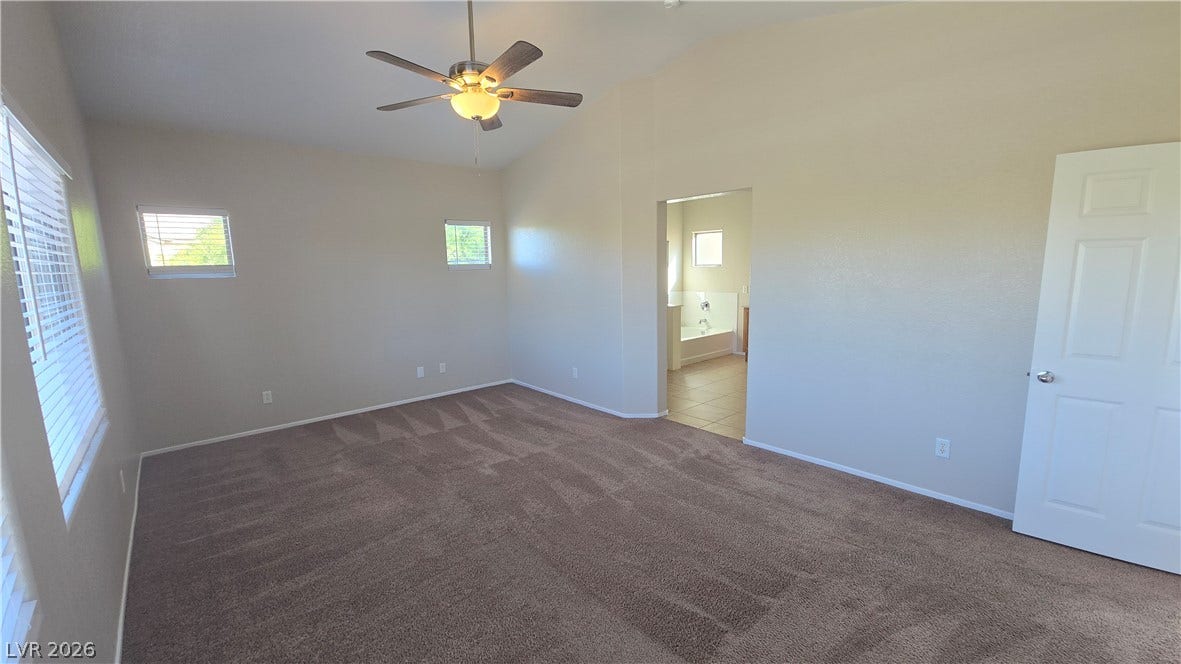 536 Civic Holiday Avenue, North Las Vegas, NV 89031 Vaulted ceilings and plush carpeting define this restful bedroom with an attached private bath.