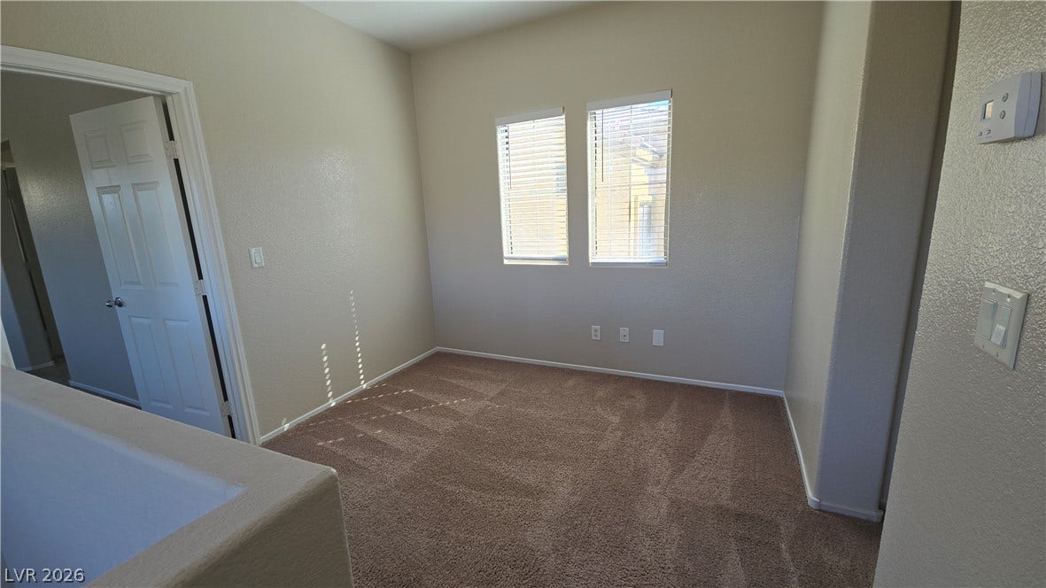 536 Civic Holiday Avenue, North Las Vegas, NV 89031 Soft carpeting underfoot defines this versatile upper-level space featuring tall windows.