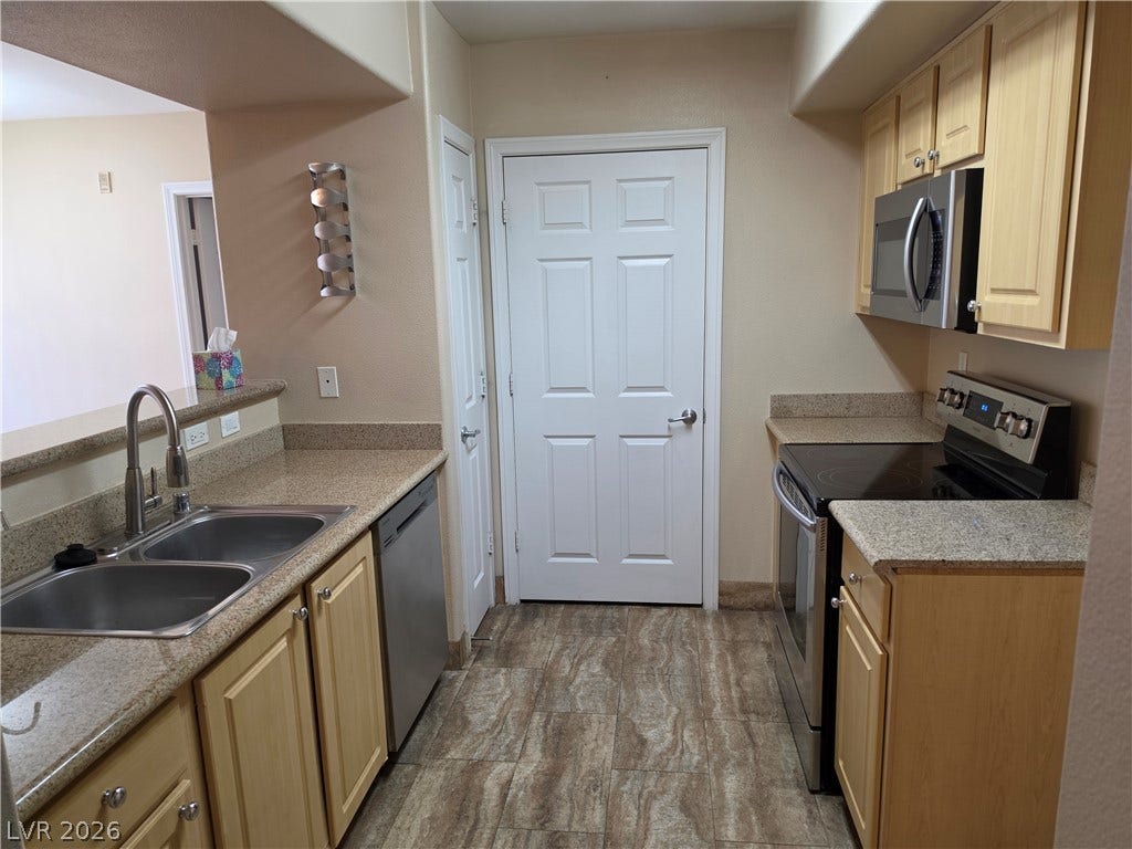 8000 W Badura Avenue, #2111, Las Vegas, NV 89113 Smooth granite countertops pair beautifully with classic cabinetry and durable tile flooring.