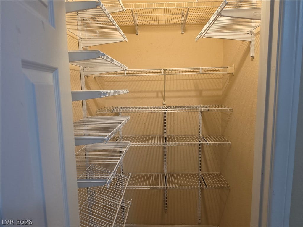 8000 W Badura Avenue, #2111, Las Vegas, NV 89113 Adjustable wire shelving maximizes storage potential in this dedicated walk-in closet space.
