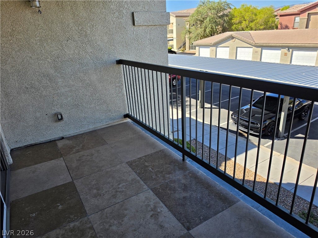 8000 W Badura Avenue, #2111, Las Vegas, NV 89113 Tiled private balcony enclosed by protective metal railings overlooks the neighborhood below.