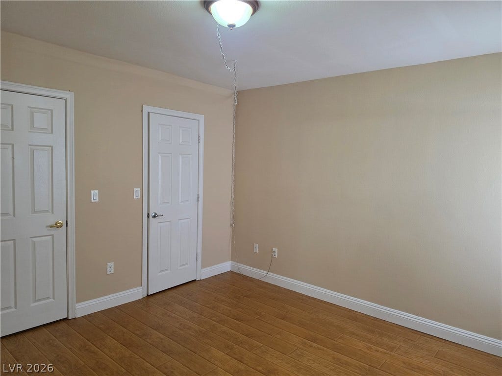 8000 W Badura Avenue, #2111, Las Vegas, NV 89113 Gleaming hardwood floors and classic panel doors ground this versatile bedroom space.
