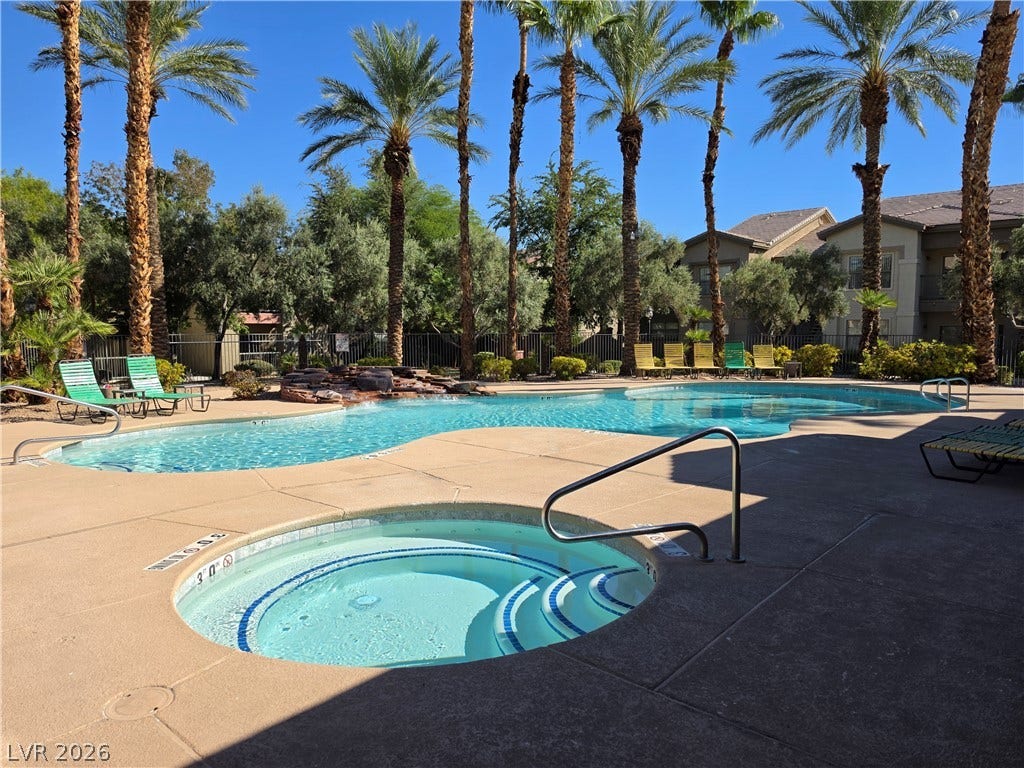 8000 W Badura Avenue, #2111, Las Vegas, NV 89113 Soaring palm trees frame the sparkling community pool and spa area.