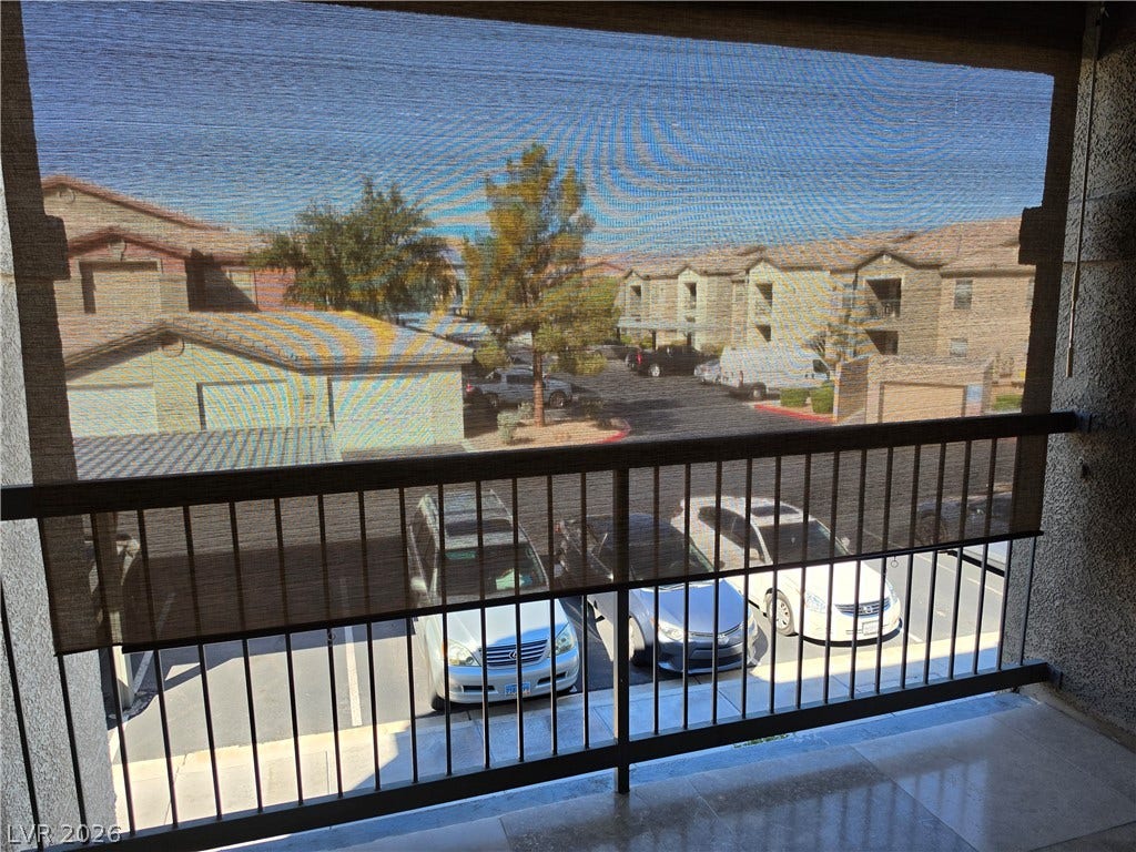 8000 W Badura Avenue, #2111, Las Vegas, NV 89113 A private upper-level balcony overlooks the surrounding community and parking area.