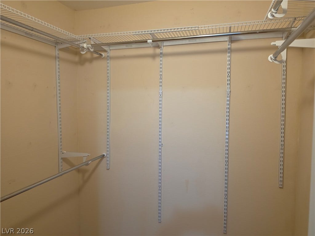 8000 W Badura Avenue, #2111, Las Vegas, NV 89113 Adjustable wire shelving and hanging rods maximize storage capacity within this functional walk-in closet.