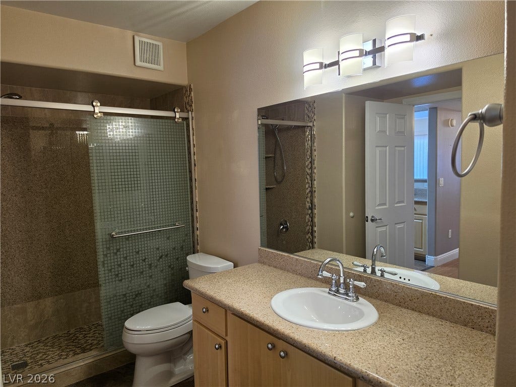 8000 W Badura Avenue, #2111, Las Vegas, NV 89113 Granite counters and tiled walk-in shower elevate this functional bathroom.